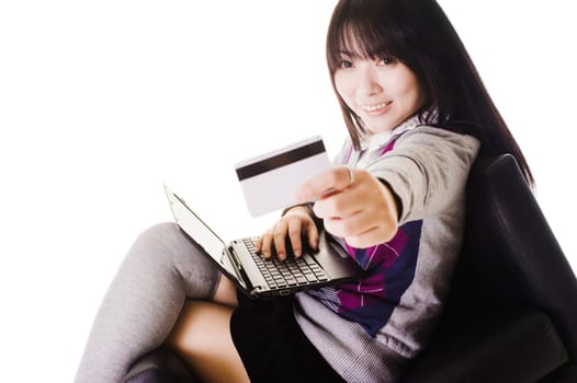 Chinese school girl holding up a credit card.