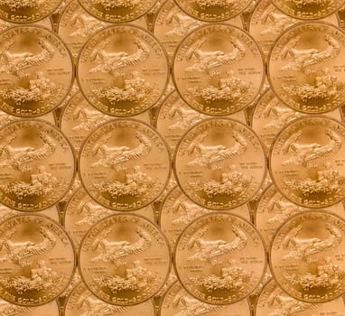 Gold Eagle one ounce coins in a patterns and stacked on each row