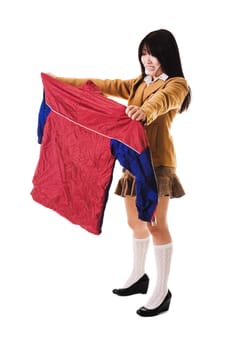 Fashionable Chinese school girl wearing a Japanese style school uniform disapproves of an ugly looking Chinese uniform.