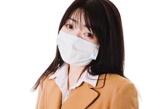 Closeup of a sick Chinese school girl wearing a face mask.