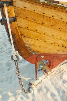 Stern with propeller of a fishing boat on the beach