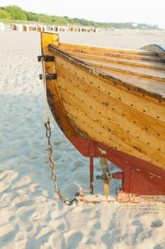 Stern with propeller of a fishing boat on the beach