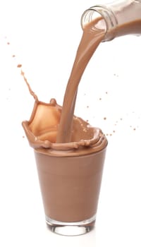 Bottle pouring milk chocolate into a glass