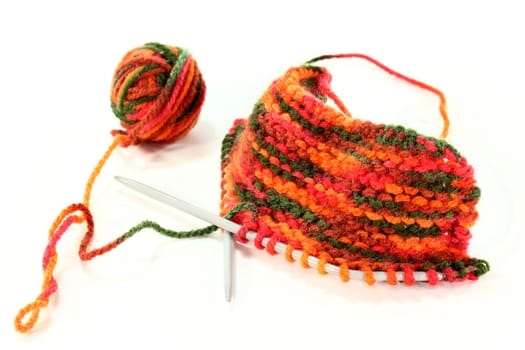 a colourful ball of wool with a knitting sample
