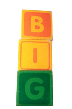 childrens toy letter building blocks against a white background spelling big