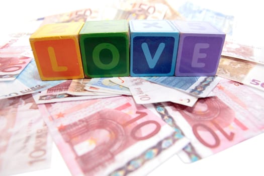 assorted childrens toy letter building blocks on money that spell love
