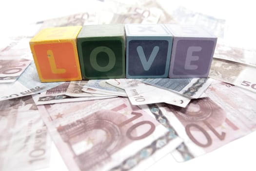 assorted childrens toy letter building blocks on money that spell love