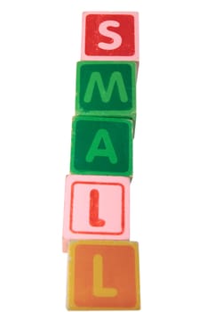 childrens toy letter building blocks against a white background spelling small
