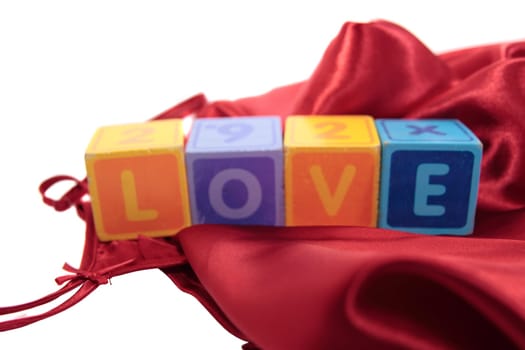 love written with blocks on a silk nightie against white background