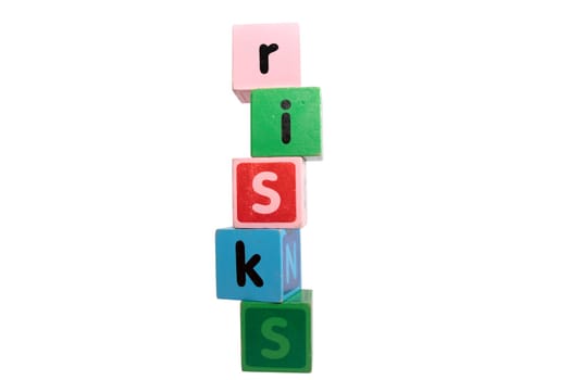 risks spelt with childrens toy letter building blocks against a white background with clipping path