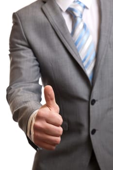 Businessman in suit giving thumbs-up sign