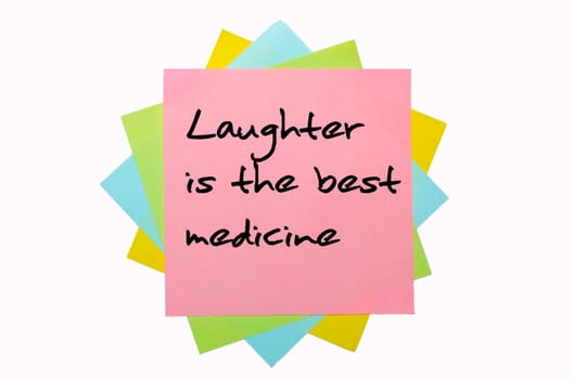 text "Laughter is the best medicine"" written by hand font on bunch of colored sticky notes"
