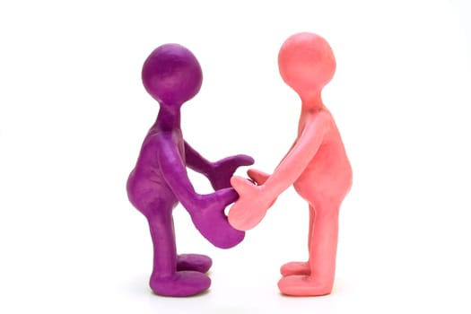 Two colored plasticine puppets standing opposite each other