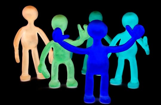 Shaded group of plasticine puppets on black background