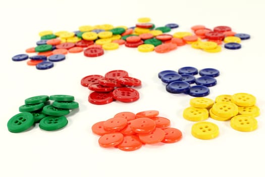 many colorful buttons in front of a white background