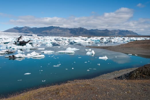 mountains and icebergs on the lake in Iceland Jokulsarlon