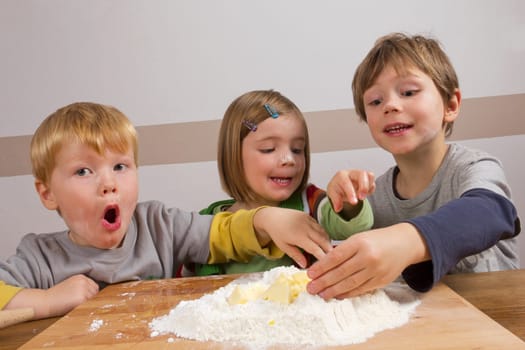 Children have fun kneading dough
