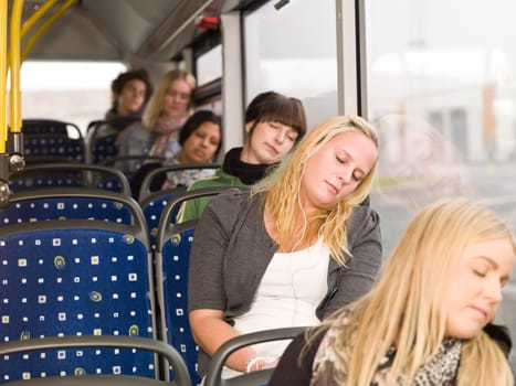 Small group of people sleeping on the bus