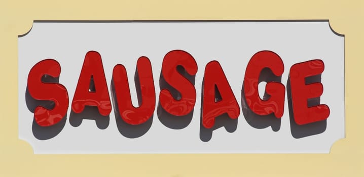 Large sausage sign near restaurant on a boardwalk