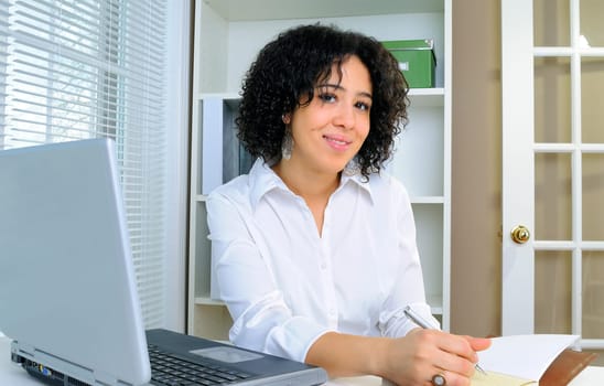 African American Business Woman Sat At Her Desk With A Laptop Computer