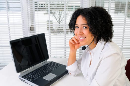 African American Business Woman Sat At Her Desk With A Laptop Computer