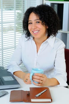 African American Business Woman Sat At Her Desk With A Laptop Computer