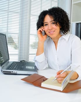 African American Business Woman Sat At Her Desk With A Laptop Computer