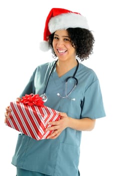 African American Hospital Nurse Holding A Christmas Gift Wearing Scrubs And a Santa Hat For The Holidays