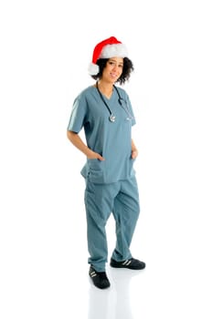 African American Hospital Nurse Wearing A Santa Hat And Hospital Scrubs At Christmas