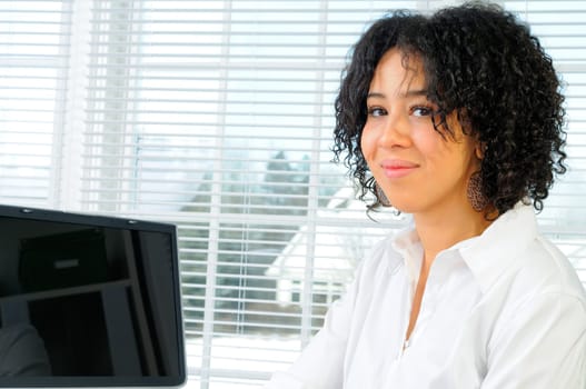 African American Business Woman Sat At Her Desk With A Computer