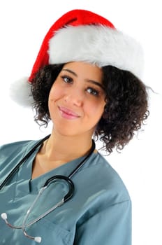 African American Hospital Nurse Wearing A Santa Hat And Hospital Scrubs At Christmas