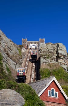 Funicular train cliff railway in Hastings England. Cable tram on hill pulley with building in foreground