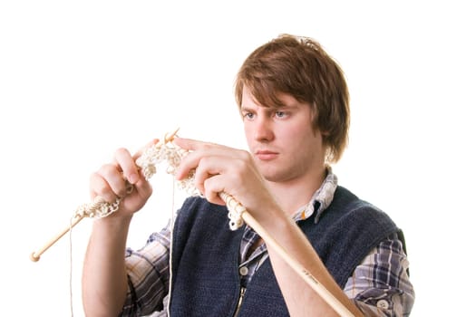 Man knitting, male working on craft knit with needles isolated on white