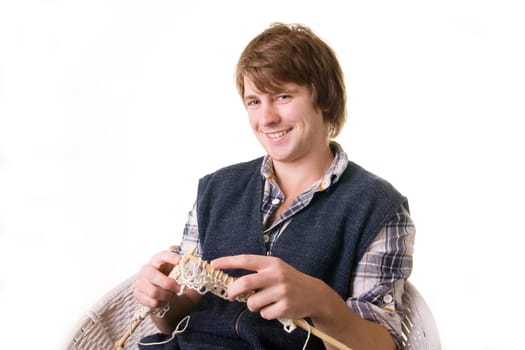 Man knitting, male working on craft knit with needles isolated on white
