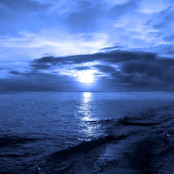Sunset bathed in blue by the sea
