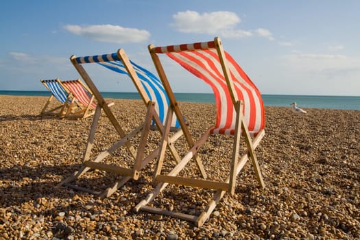 deck chair on beach in brighton. Sun lounger at the seaside in england on windy day