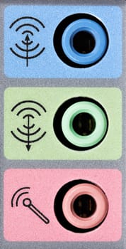 Closeup of audio input and output ports from the sound card in a computer.