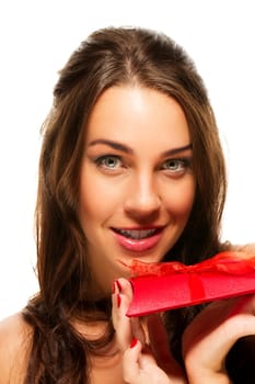 Beautiful woman holding red gift on white background