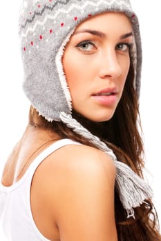 Beautiful woman in winter hat looking over her shoulder on white background