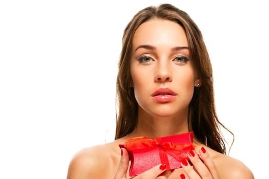 Beautiful woman holding red gift on white background