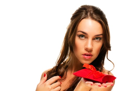 Beautiful woman showing red gift on white background