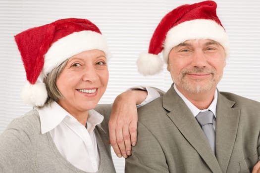 Laughing senior businesspeople having fun with Xmas Santa hat