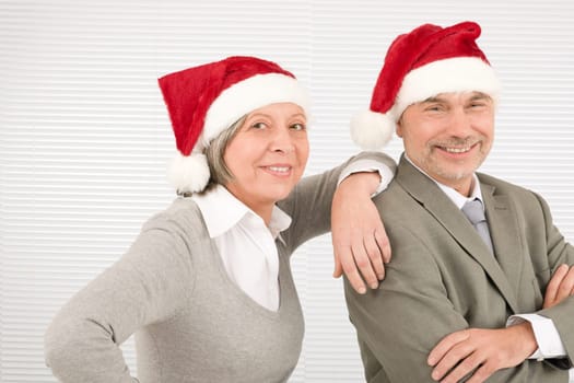 Christmas senior businesspeople having fun with Xmas hat