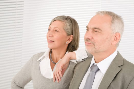 Professional senior businesspeople looking aside bright future