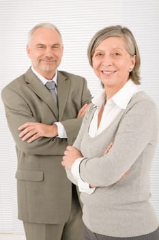 Professional elegant smiling senior businesspeople standing with cross arms