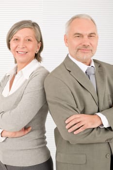 Professional elegant smiling senior businesspeople standing with cross arms