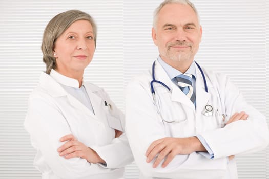 Medical team senior male doctor with professional female colleague portrait