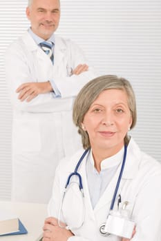 Medical senior doctor female work computer with professional male colleague