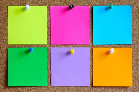 colorful sticky notes on cork pinboard