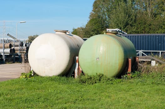 white and green storage tanks